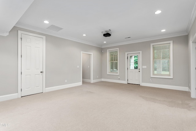 carpeted spare room featuring crown molding