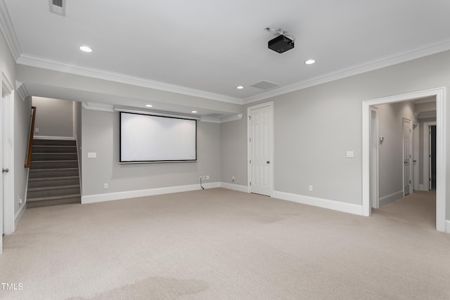 home theater room featuring light colored carpet and ornamental molding