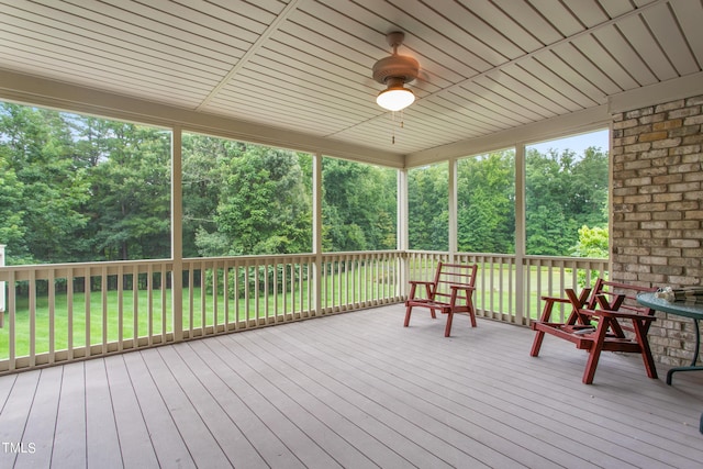 wooden terrace featuring a lawn