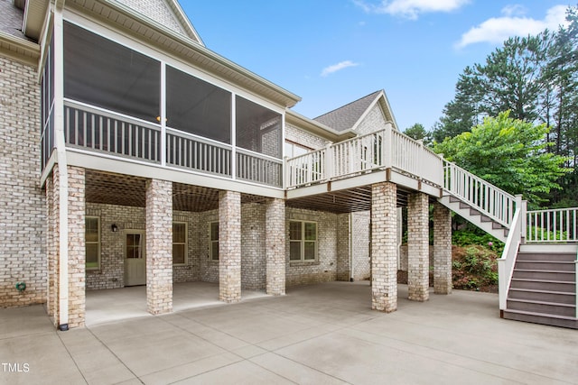 back of house with a sunroom and a patio