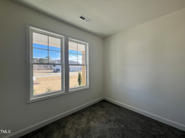 empty room featuring dark carpet