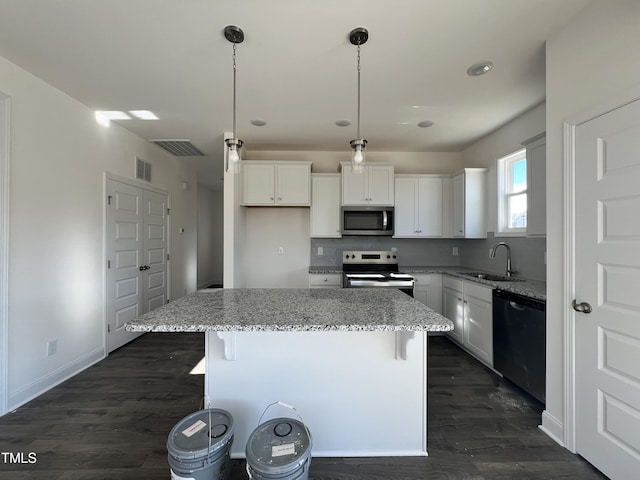 kitchen featuring white cabinets, sink, a center island, and stainless steel appliances