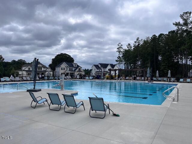 community pool with a patio area