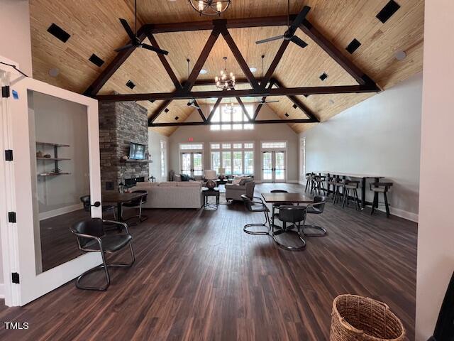 living room featuring wood ceiling, high vaulted ceiling, ceiling fan, and dark wood-style flooring