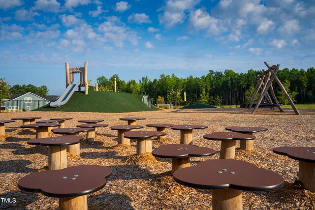 view of yard featuring playground community and fence