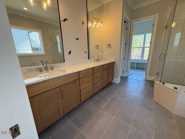 full bath with double vanity, tile patterned flooring, a sink, and a shower stall