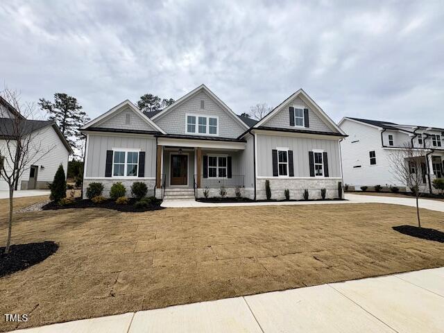 craftsman inspired home with a front lawn and board and batten siding