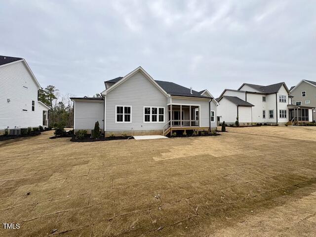 rear view of house featuring a sunroom