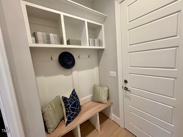 mudroom featuring light wood-style flooring and baseboards