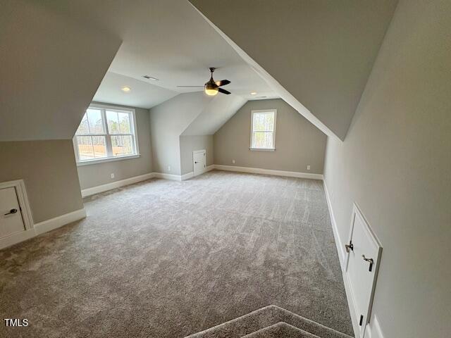 bonus room with carpet floors, lofted ceiling, and baseboards