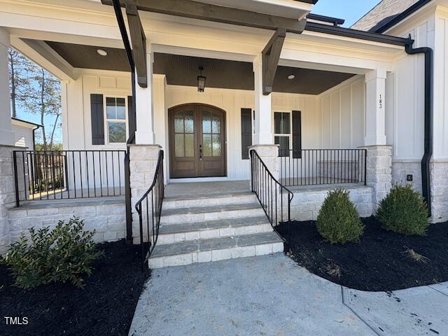 doorway to property featuring french doors and covered porch