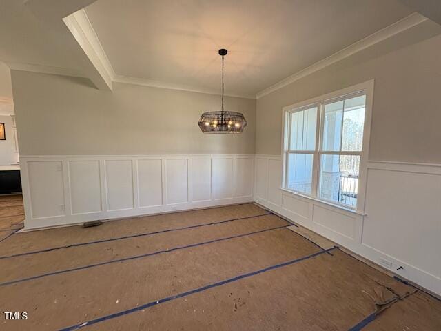 unfurnished dining area with a notable chandelier and ornamental molding