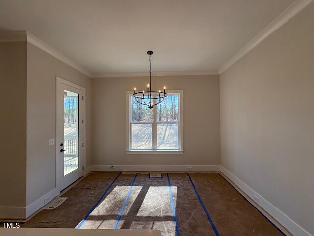 unfurnished dining area featuring an inviting chandelier and ornamental molding