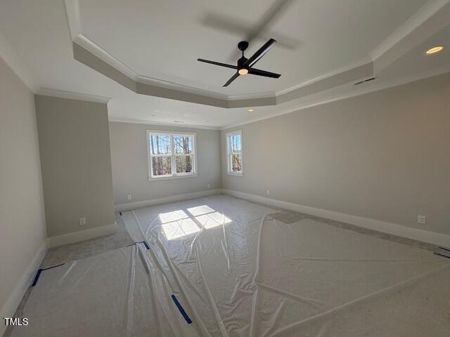 unfurnished room featuring ornamental molding, ceiling fan, and a tray ceiling