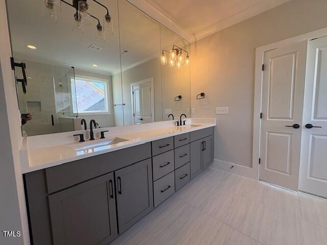 bathroom featuring vanity, ornamental molding, and a shower with shower door