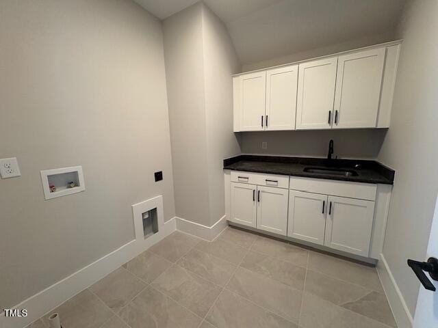 laundry room with light tile patterned flooring, cabinets, hookup for a washing machine, and sink