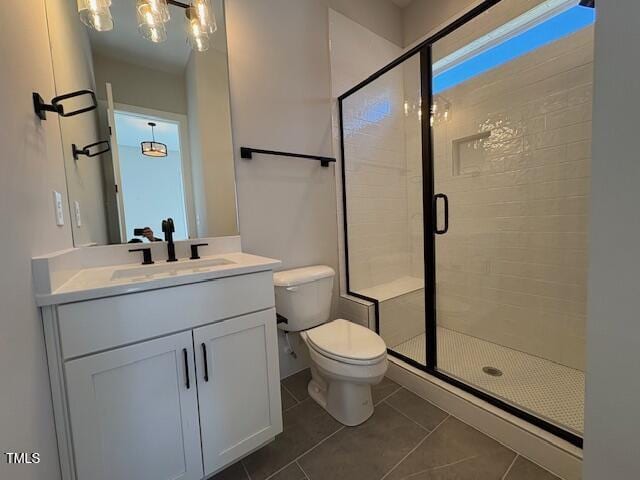 bathroom with vanity, tile patterned floors, toilet, and walk in shower