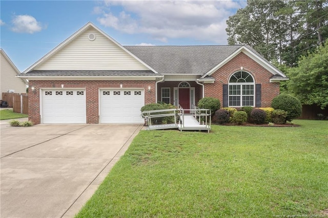 ranch-style house featuring brick siding, driveway, an attached garage, and a front yard