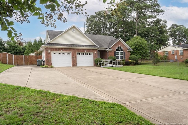 view of front of house with driveway, a front lawn, fence, a garage, and brick siding