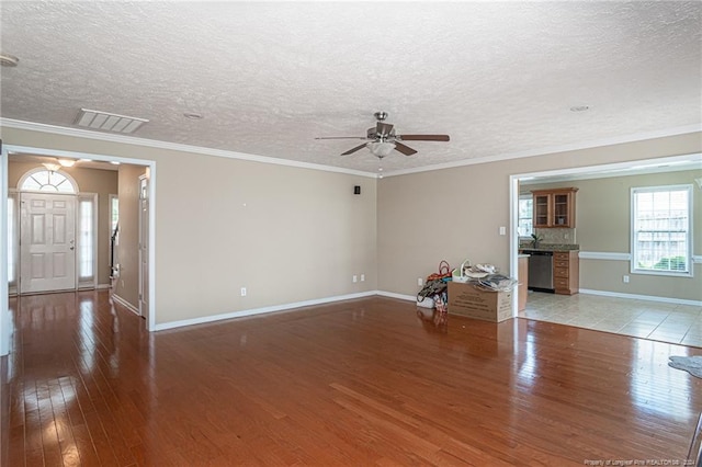 unfurnished living room featuring ceiling fan, a textured ceiling, light tile patterned floors, and crown molding