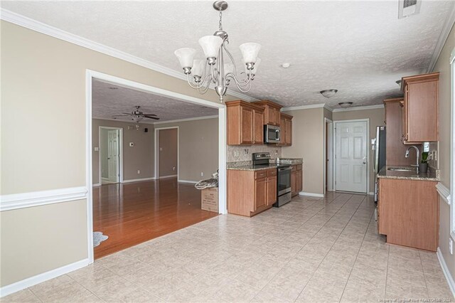 kitchen with decorative light fixtures, light tile patterned floors, crown molding, and stainless steel appliances