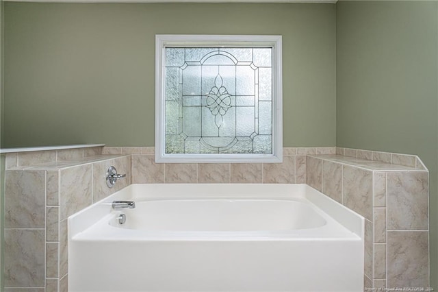 bathroom with a tub to relax in and plenty of natural light