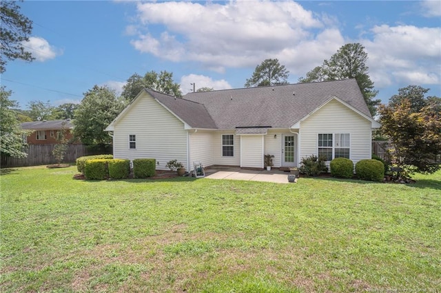 back of house featuring a patio, a lawn, and fence