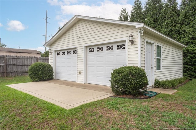 detached garage featuring fence