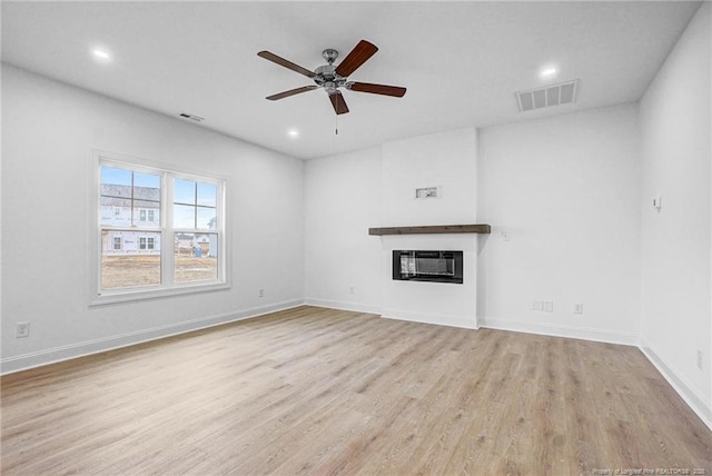 unfurnished living room featuring light hardwood / wood-style flooring and ceiling fan