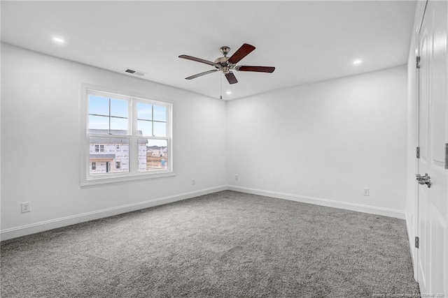 carpeted spare room featuring ceiling fan