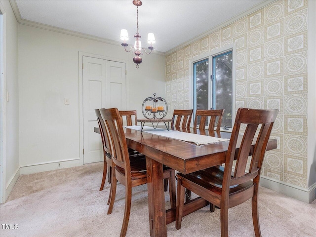 dining area with ornamental molding, light colored carpet, and a chandelier