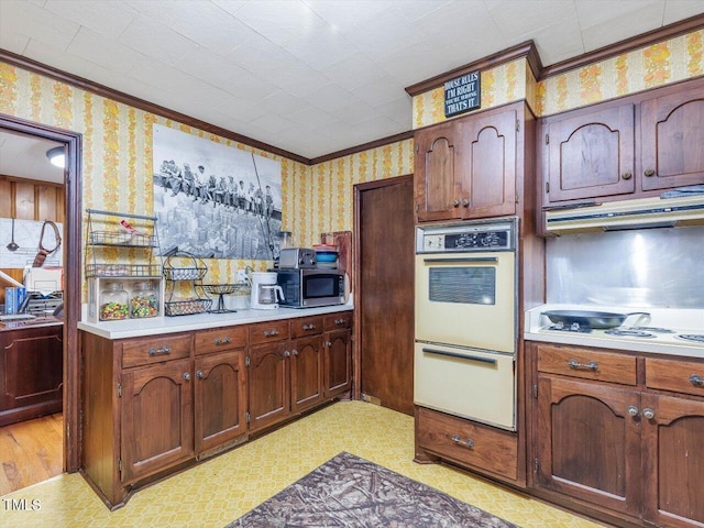 kitchen with light wood-type flooring, crown molding, ventilation hood, and white appliances