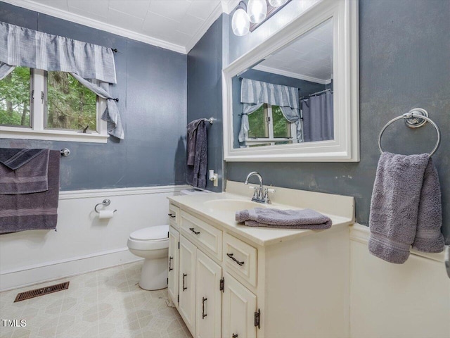 bathroom with ornamental molding, vanity, and toilet