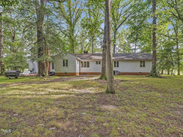 rear view of property featuring a yard