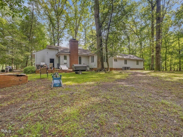 back of house featuring a hot tub and a wooden deck