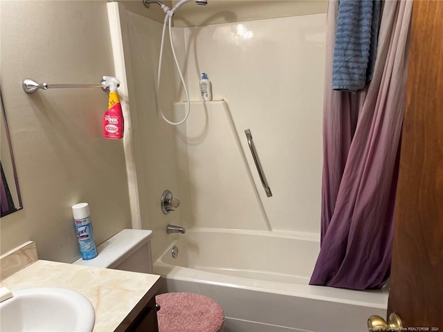 bathroom featuring toilet, shower / bath combo with shower curtain, and vanity