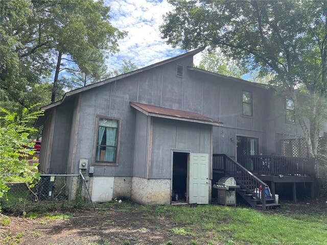 back of house featuring a deck