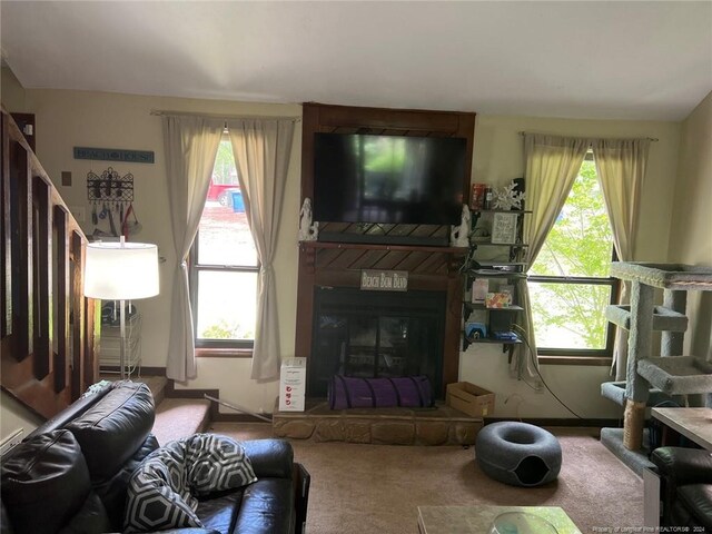 living room featuring carpet flooring and a fireplace