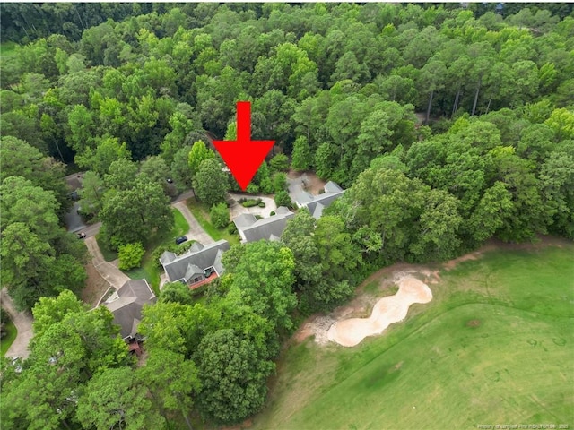 birds eye view of property featuring a wooded view