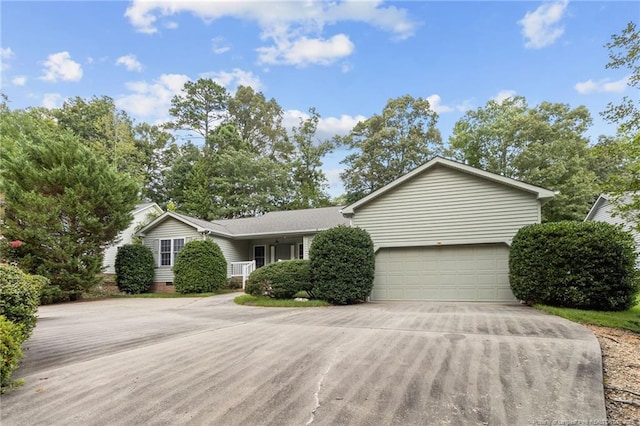 single story home with concrete driveway