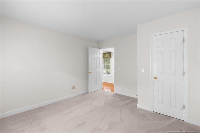 unfurnished bedroom with baseboards and carpet
