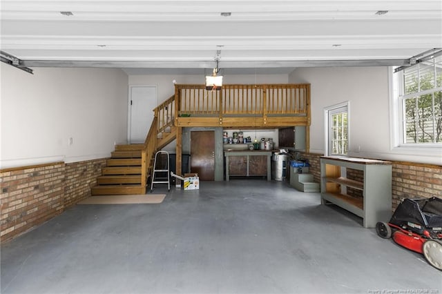 garage with a garage door opener and a workshop area
