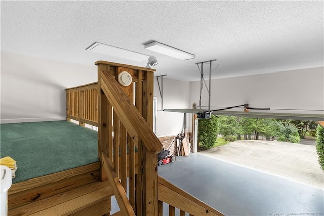 stairs featuring a textured ceiling and carpet flooring