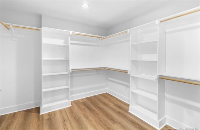 spacious closet featuring hardwood / wood-style floors