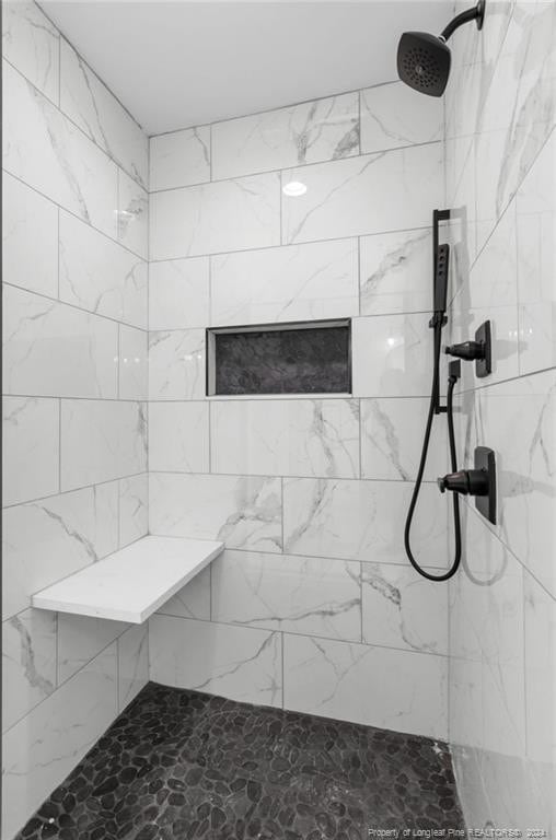 bathroom with a tile shower