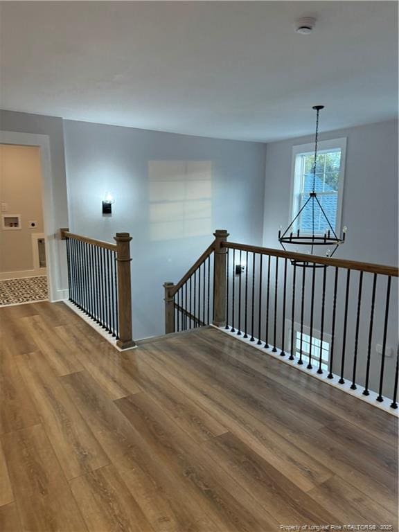 interior space featuring wood finished floors and a notable chandelier