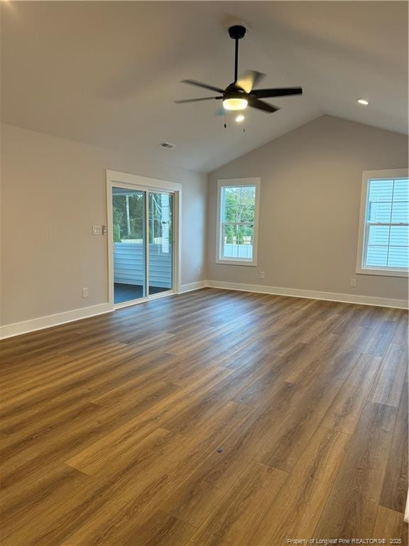 spare room featuring lofted ceiling, ceiling fan, baseboards, and wood finished floors