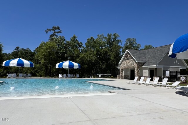 view of pool featuring pool water feature and a patio area