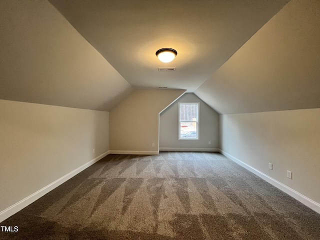 bonus room featuring vaulted ceiling and carpet floors