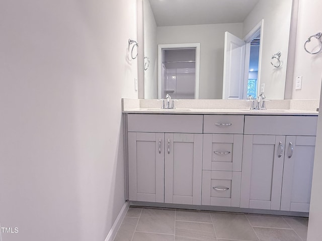 bathroom featuring tile patterned flooring and vanity